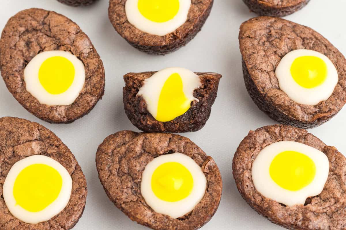 a halved and upturned creme egg brownie showing the filling surrounded by whole brownies.