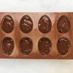 egg-shaped silicone mold filled with brownie batter.