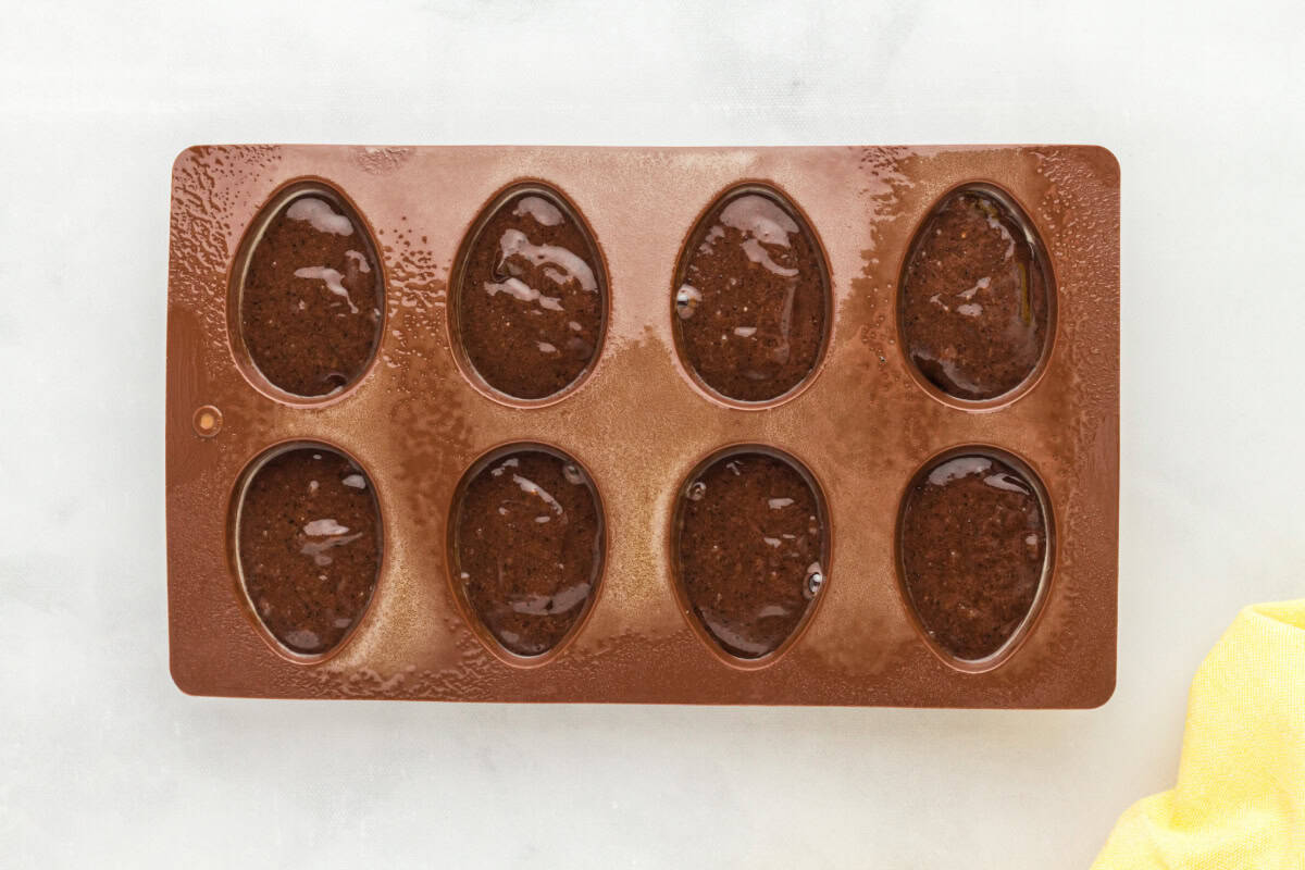 egg-shaped silicone mold filled with brownie batter.