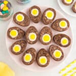 12 creme egg brownies arranged like deviled eggs on a circular tray.