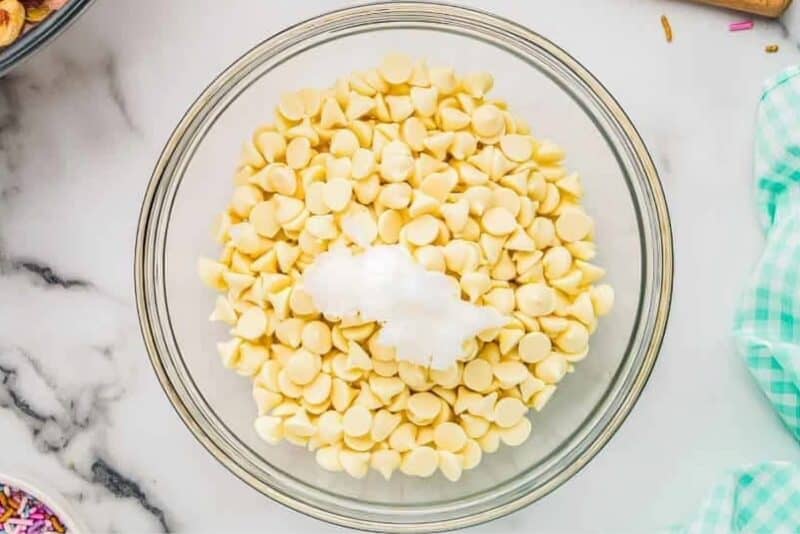 White chocolate chips in a bowl before melting.
