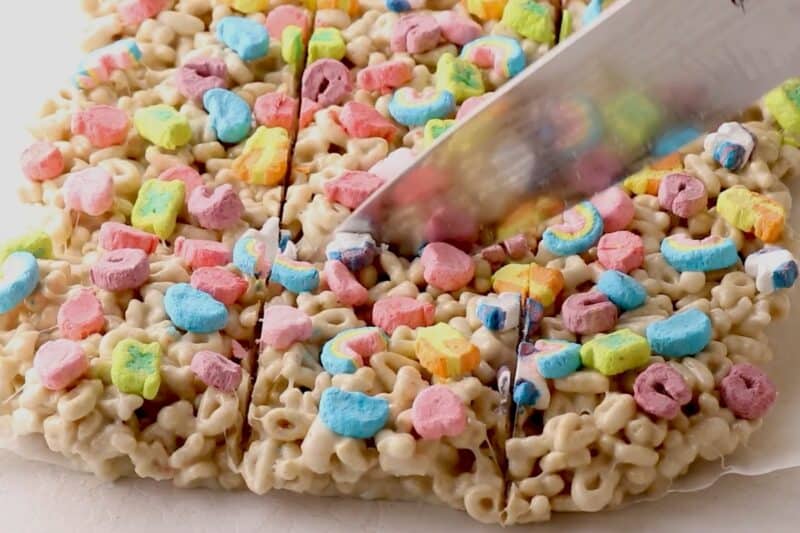 Slicing Lucky Charms treats into square bars.
