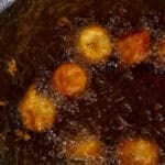 Frying the bananas in hot oil.