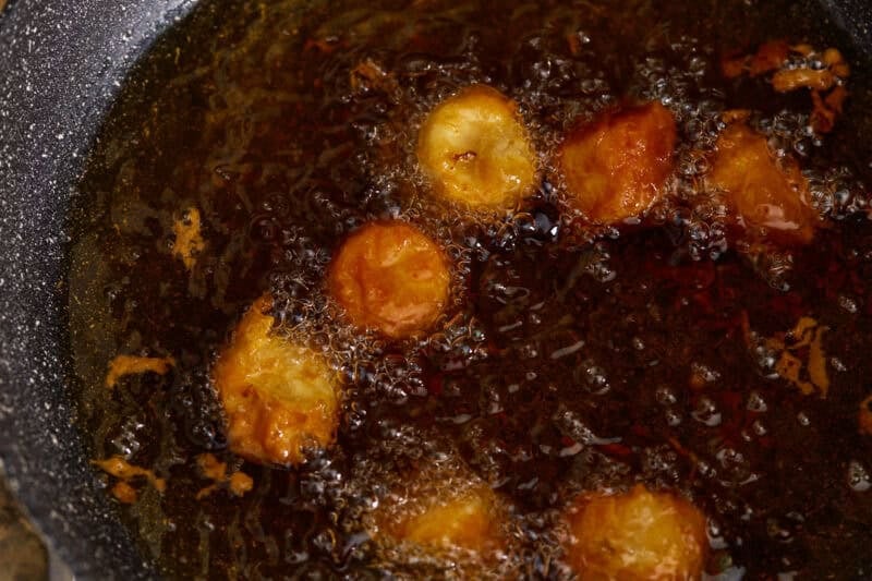 Frying the bananas in hot oil.