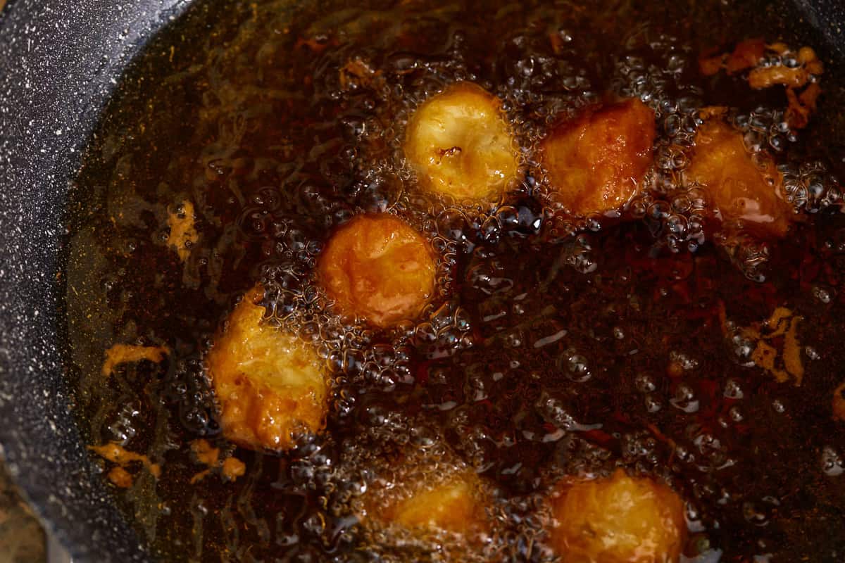 Frying the bananas in hot oil.