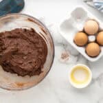Brownie mix, oreos, eggs and butter mixed together in a large bowl.