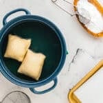 Frying the sopapillas in oil.