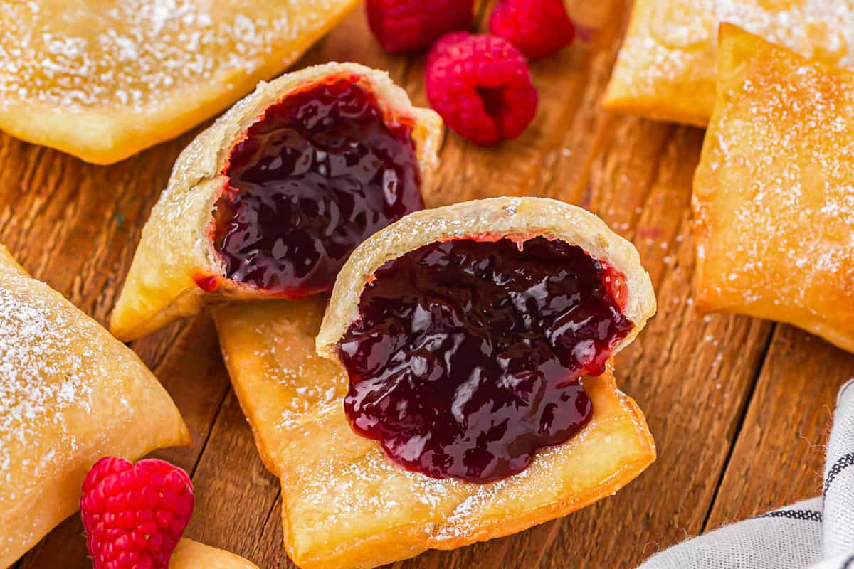 A sopapilla broken in half to reveal the jam filling.