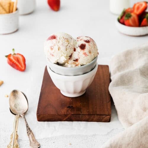 Scoops of strawberry cheesecake ice cream served in a small bowl.