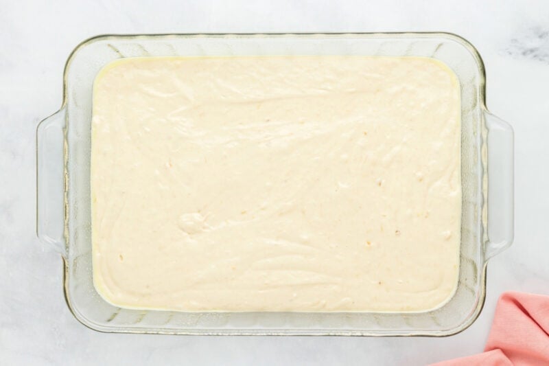 Cake batter in a 9x13 rectangle pan.