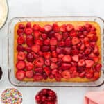 Sliced strawberries on top of the cake.