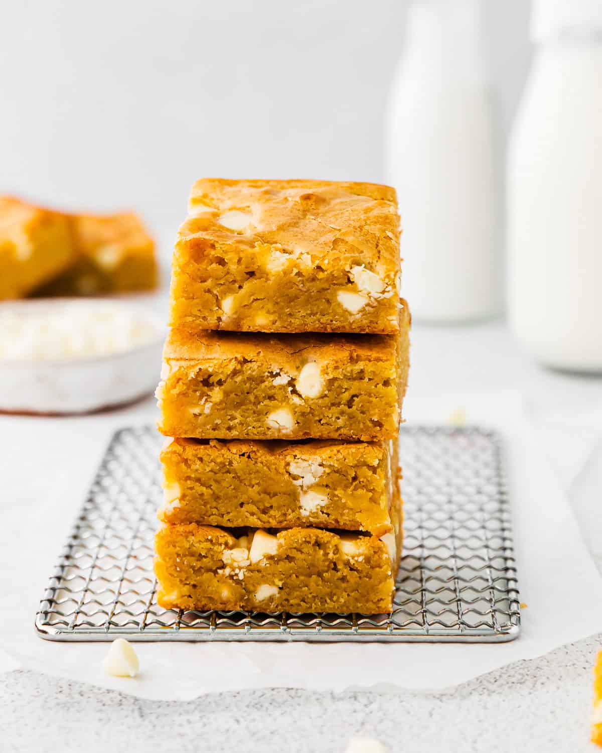 A stack of blondies filled with white chocolate chips.