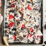 Frozen yogurt bark broken up on a baking sheet.