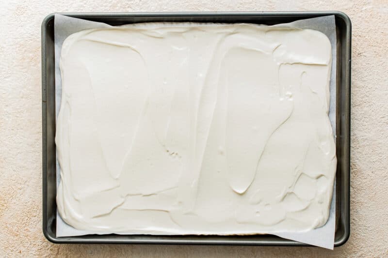 Yogurt mixture spread in the baking tin.