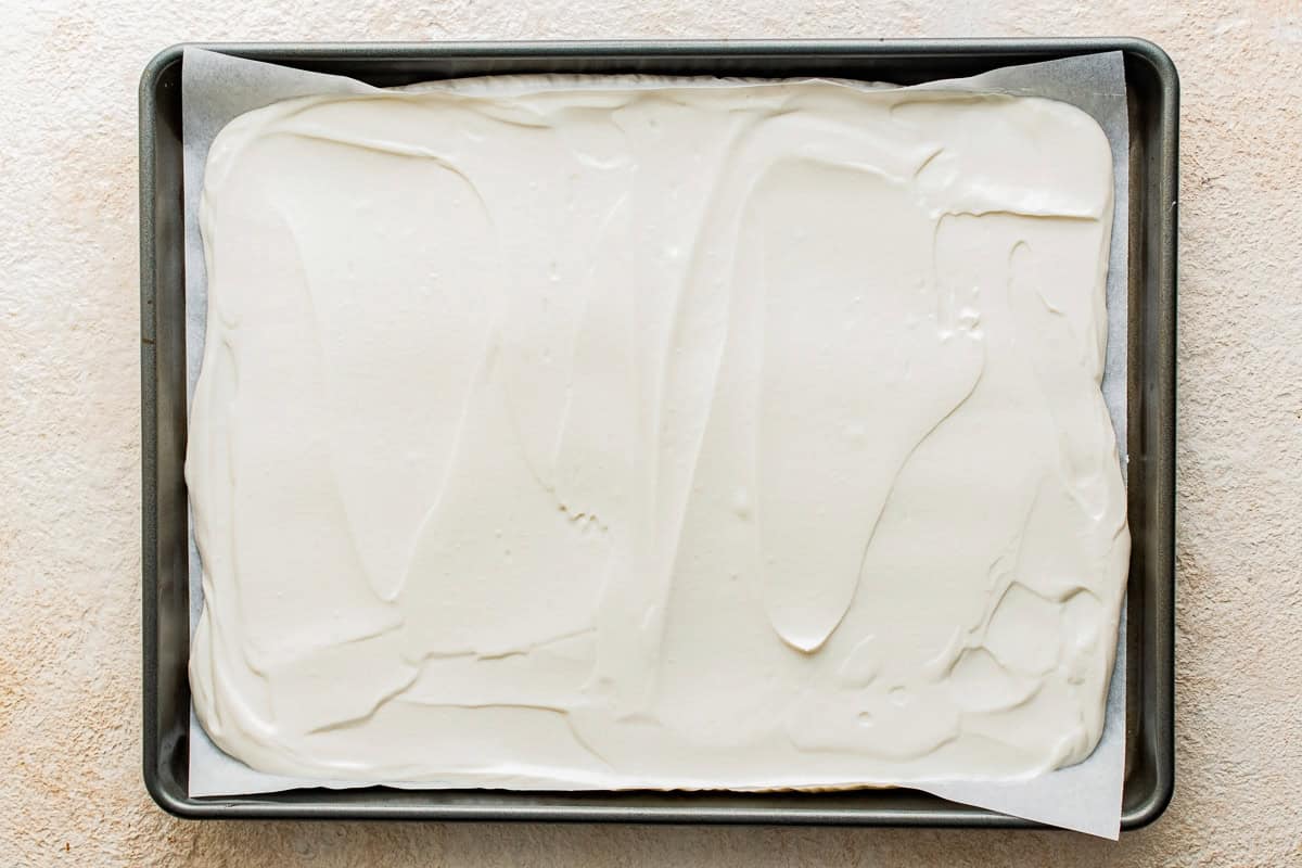 Yogurt mixture spread in the baking tin.