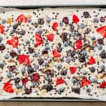 Berries, nuts and chocolate chips sprinkled on top of the yogurt.