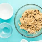 Chocolate chips folded in to cookie dough.