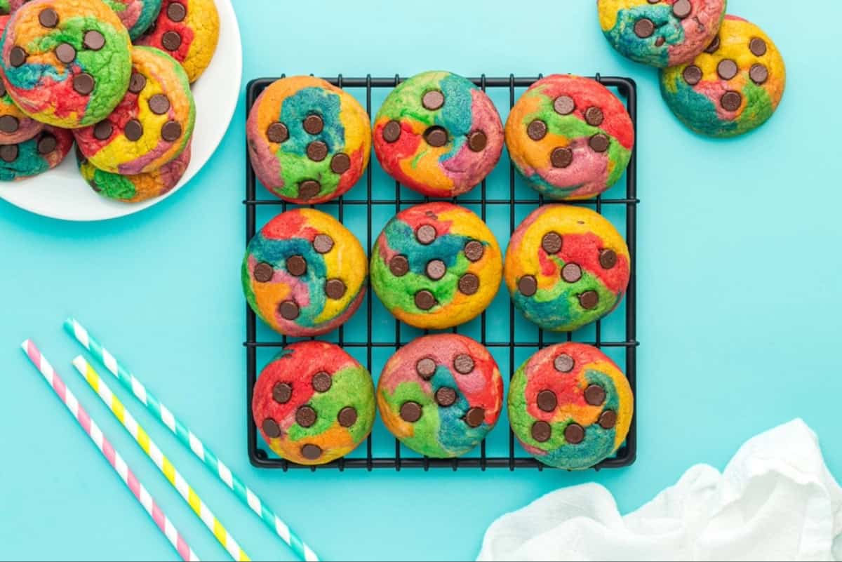 Nine rainbow cookies on a cooling rack.