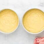 Cherry cheesecake cake batter in two cake pans.