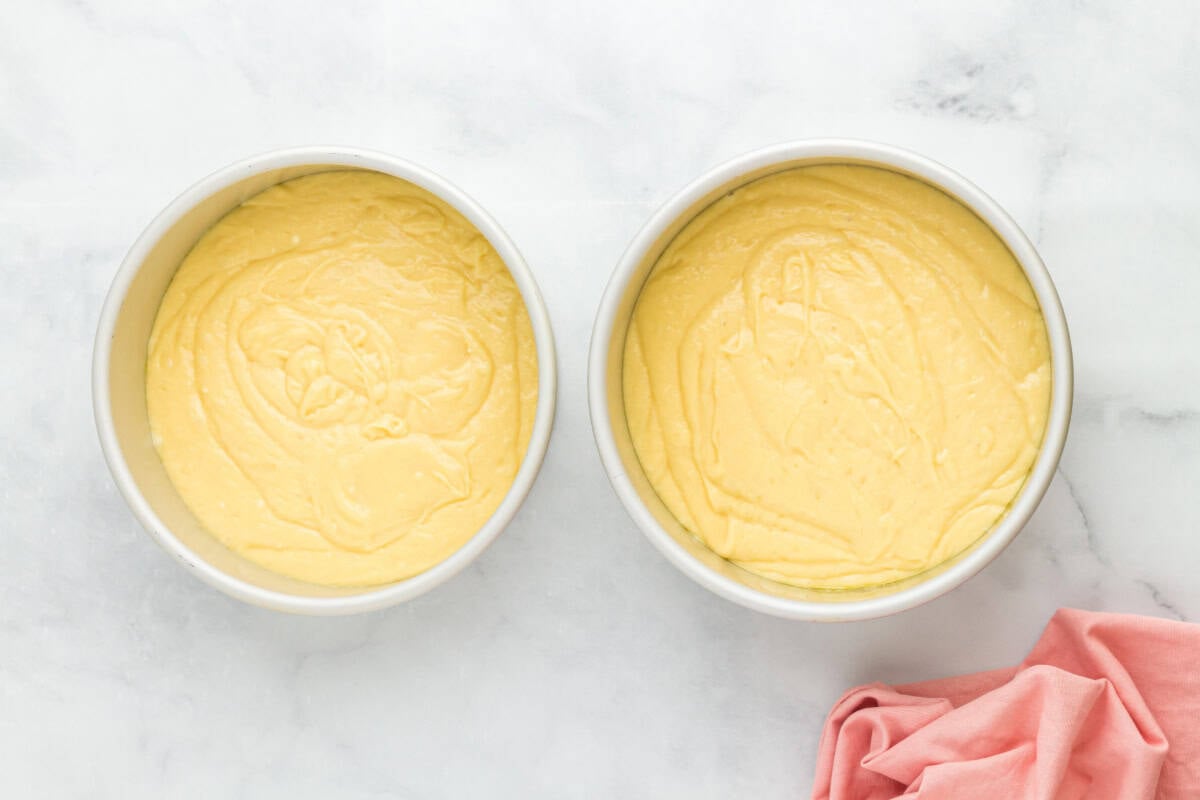Cherry cheesecake cake batter in two cake pans.