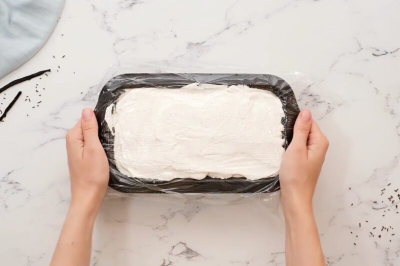 Placing no churn ice cream into the freezer.