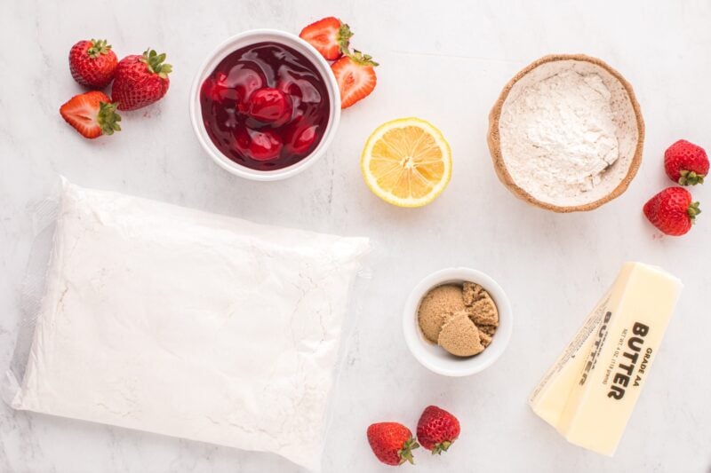 Ingredients for strawberry crumble bars include white cake mix, all-purpose flour, salted butter, strawberry pie filling, lemon juice, and light brown sugar.