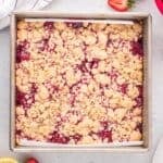 Strawberry crumble bars in a baking pan fresh out of the oven.