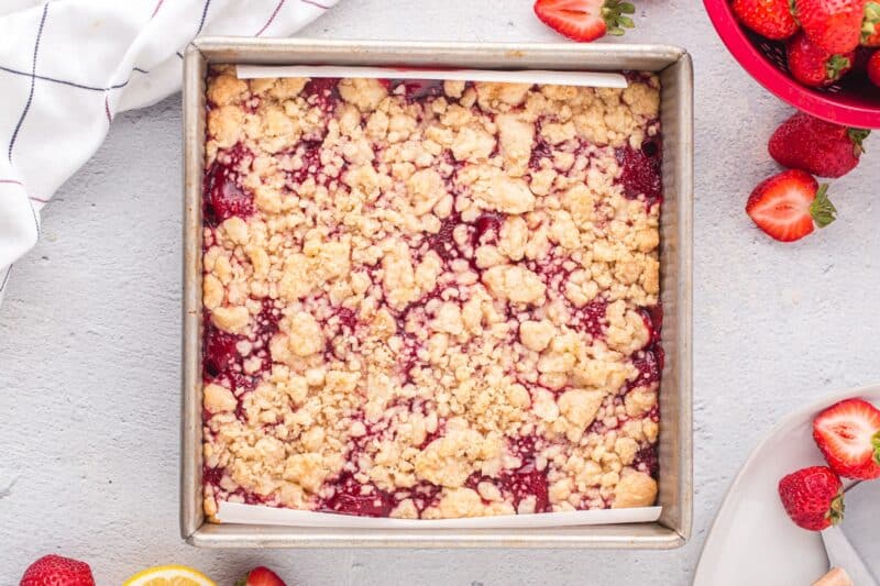 Strawberry crumble bars in a baking pan fresh out of the oven.
