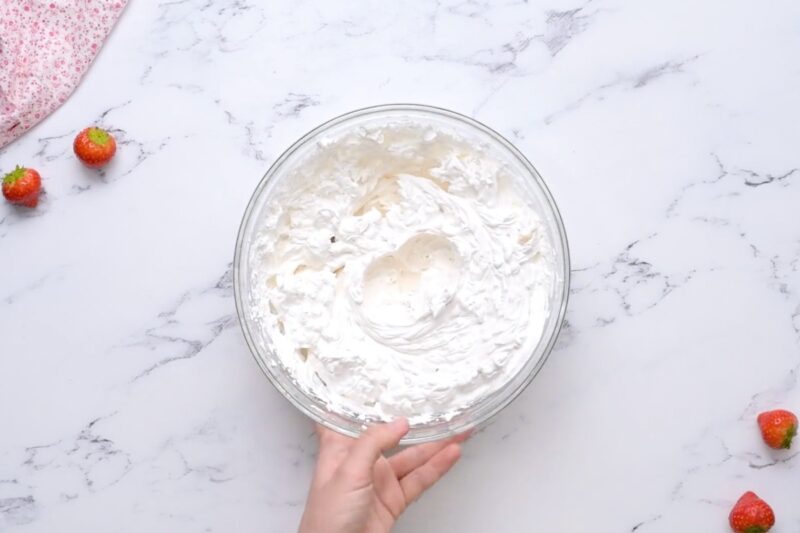 Sweetened whipped cream in a bowl.