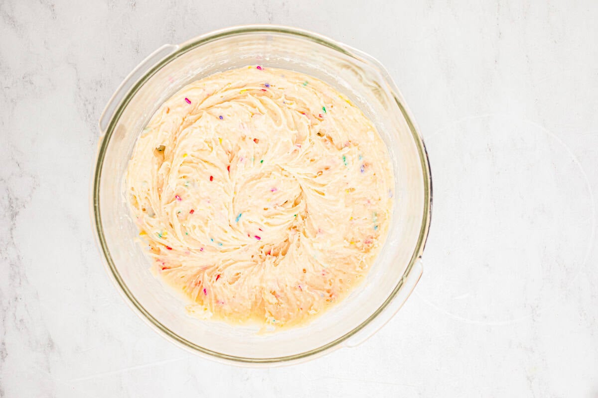 Funfetti cake batter in a glass mixing bowl.