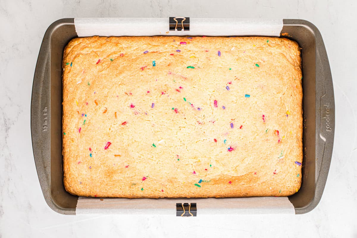 Funfetti cake bar in a baking pan fresh out of the oven.