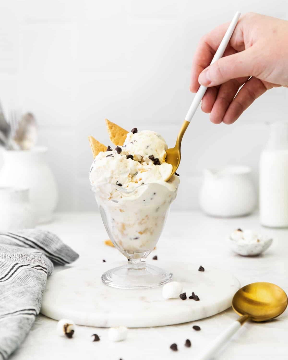 Spoon scooping into a cup of s'mores ice cream.