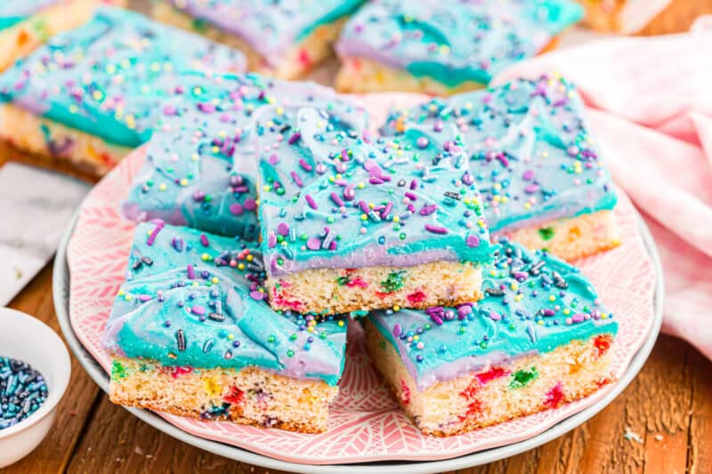 Unicorn bars stacked on each other on a serving plate.