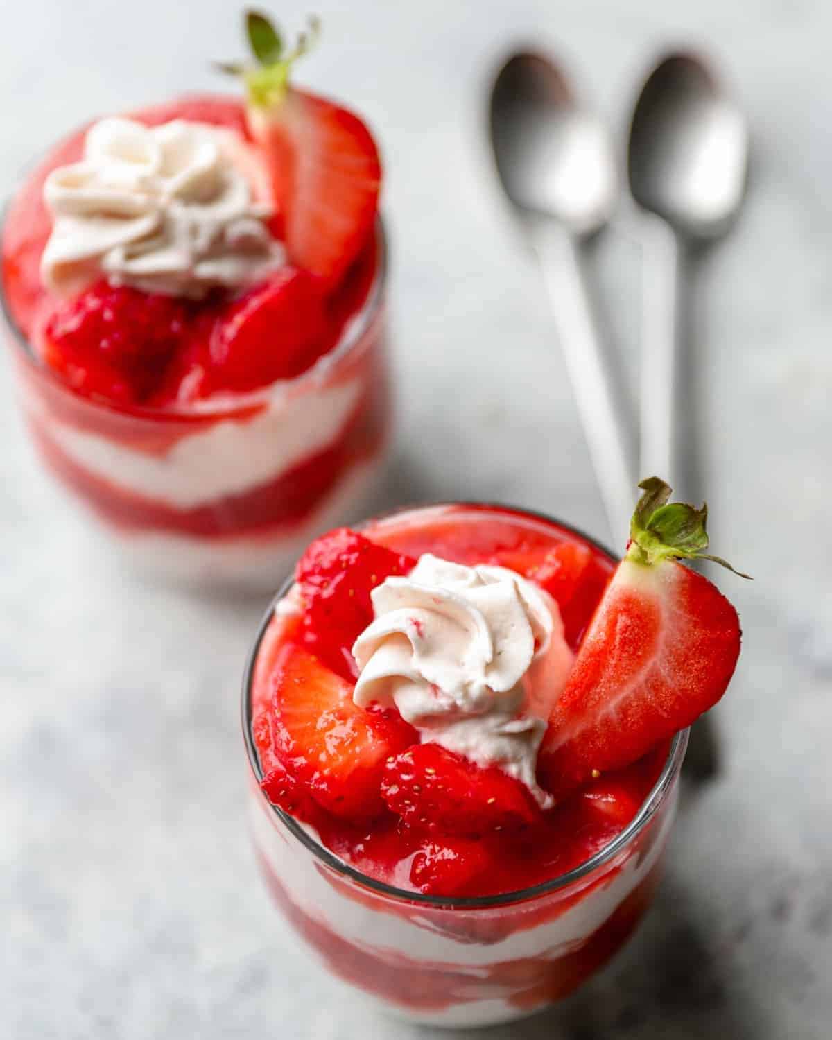2 strawberry fool desserts with spoons.