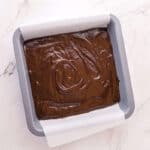 Brownie batter spread into a 9x9 baking dish.