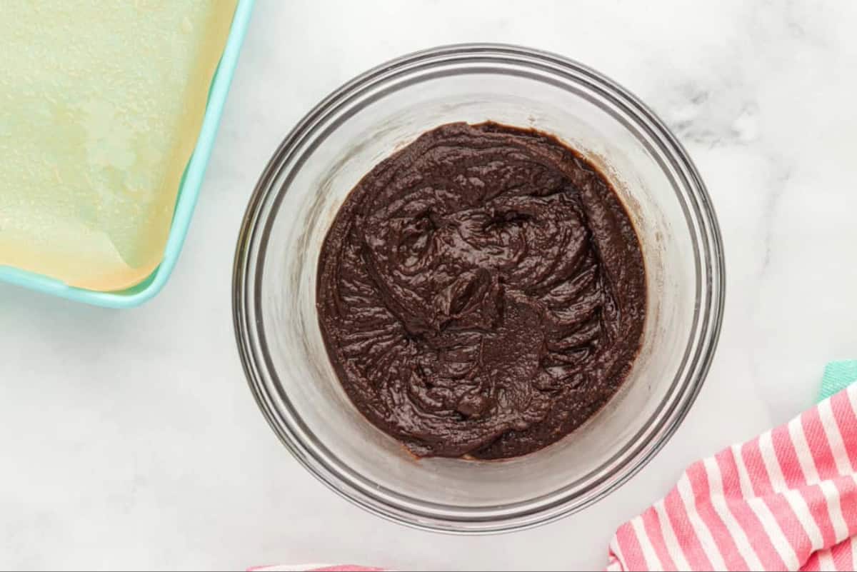 Chocolate cookie crust batter in a mixing bowl.