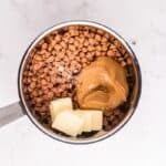 Peanut butter, butter, and butterscotch chips in a saucepan.