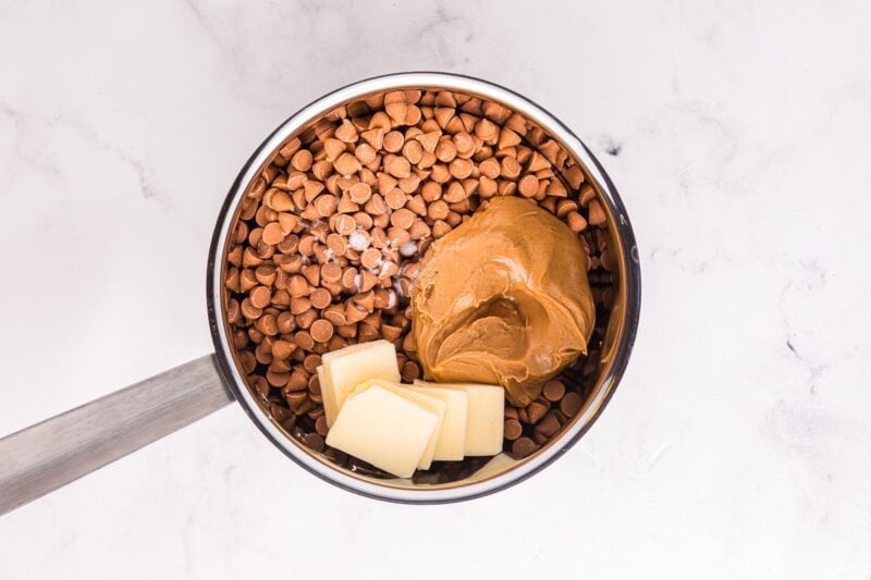 Peanut butter, butter, and butterscotch chips in a saucepan.