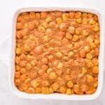 Peanut butter marshmallow mixture spread into a square baking pan.