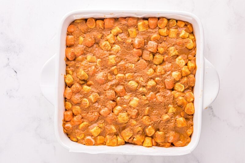Peanut butter marshmallow mixture spread into a square baking pan.