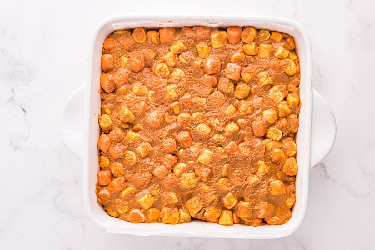 Peanut butter marshmallow mixture spread into a square baking pan.
