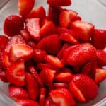 Fresh sliced strawberries in a bowl.