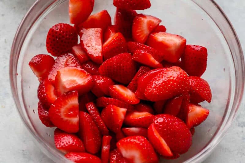Fresh sliced strawberries in a bowl.