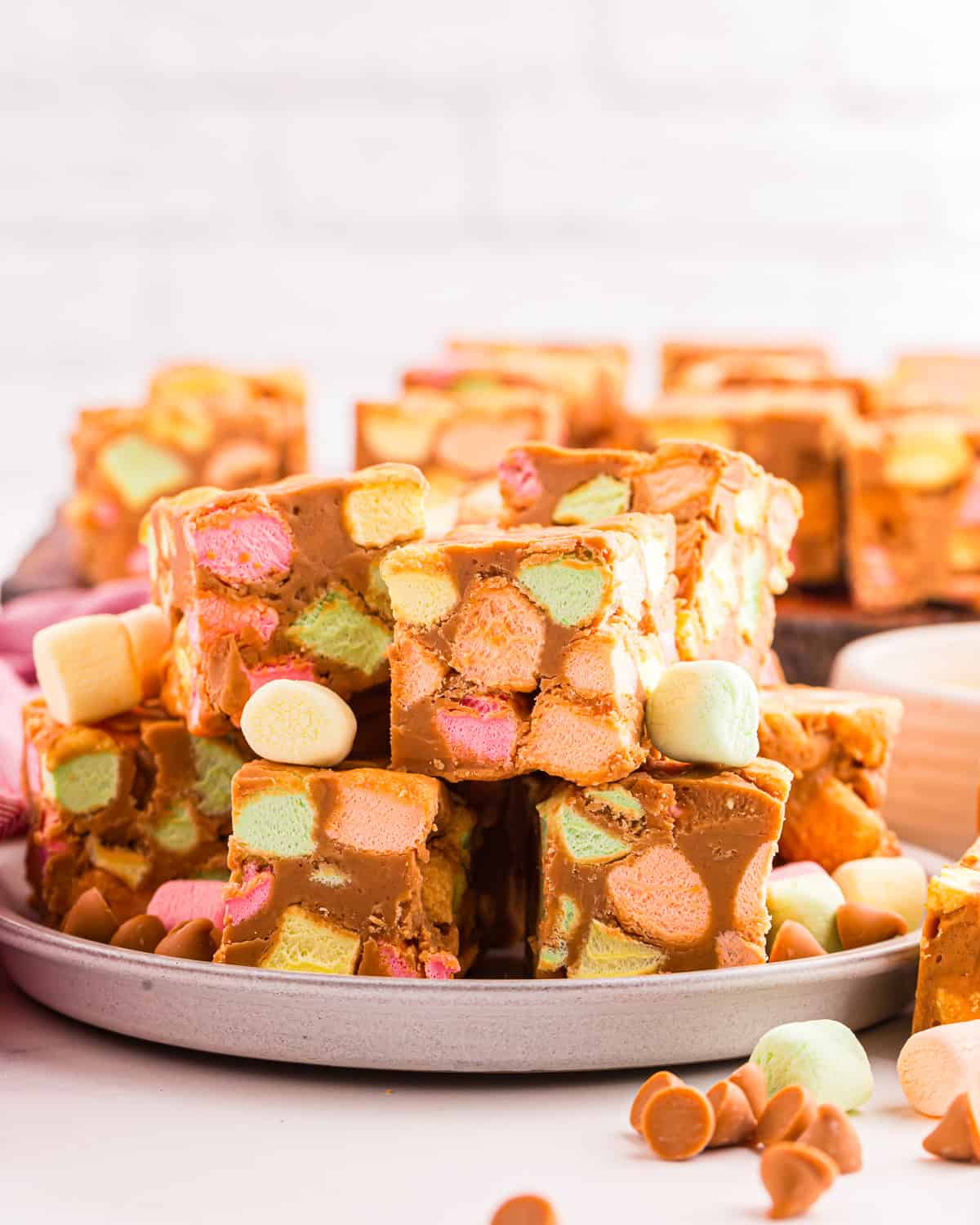 A stack of peanut butter marshmallow squares on a plate.