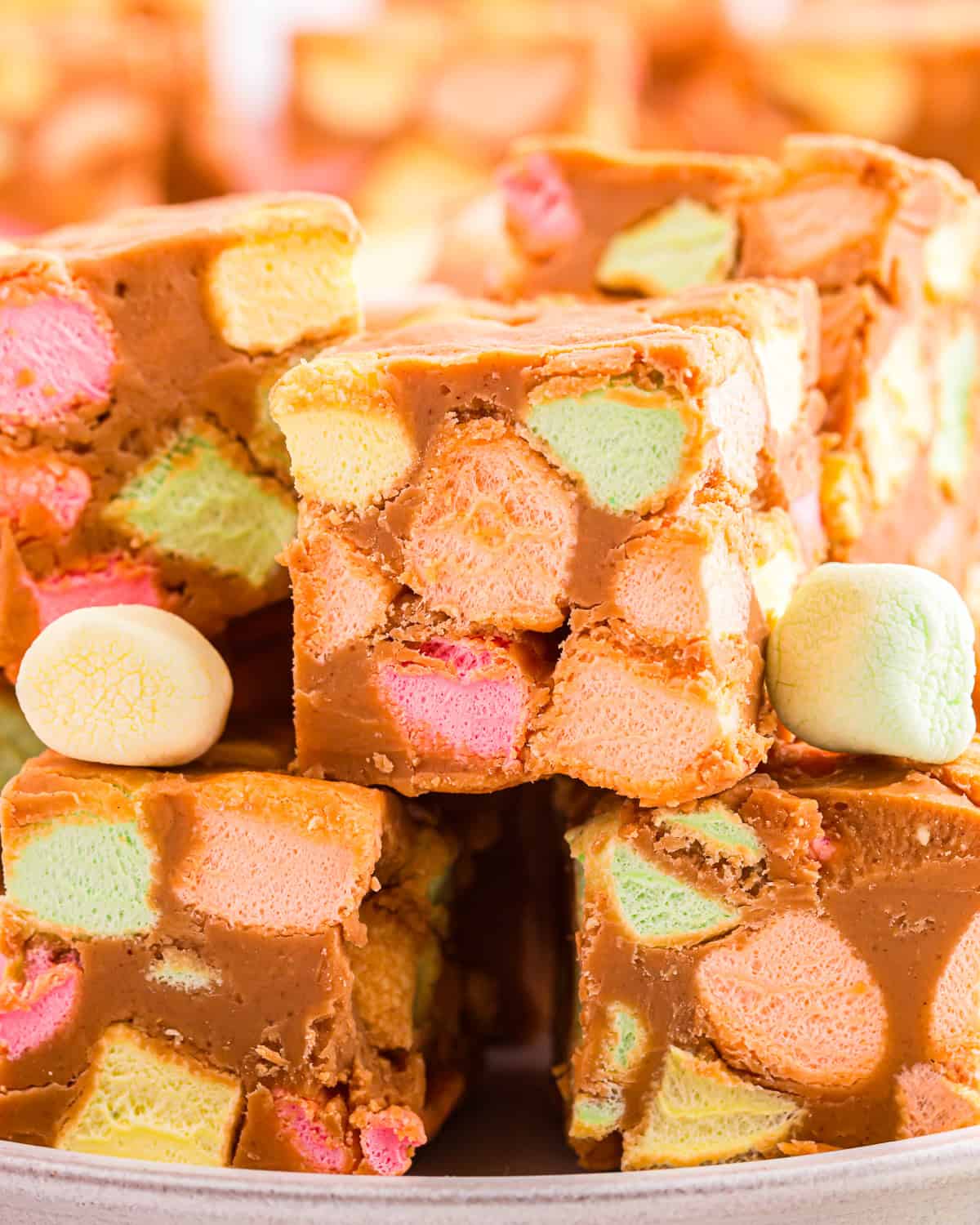 Peanut butter marshmallow squares filled with rainbow marshmallows.