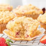 An unwrapped fresh strawberry streusel muffin.