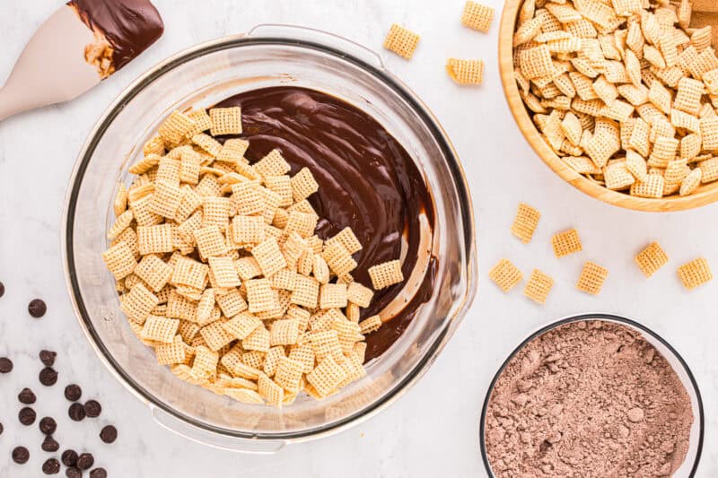 Rice Chex cereal and melted chocolate in a large mixing bow.