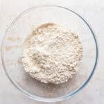 A glass mixing bowl of flour.