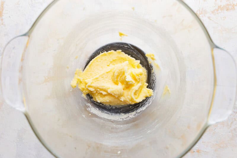 Creamed butter and sugar in a glass mixing bowl.