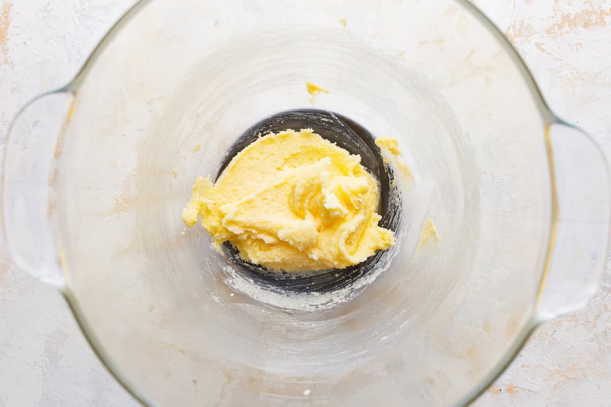 Creamed butter and sugar in a glass mixing bowl.